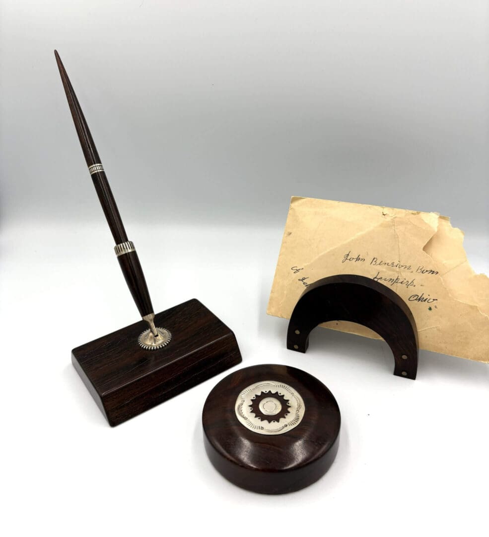Wooden desk set with envelope and stand.