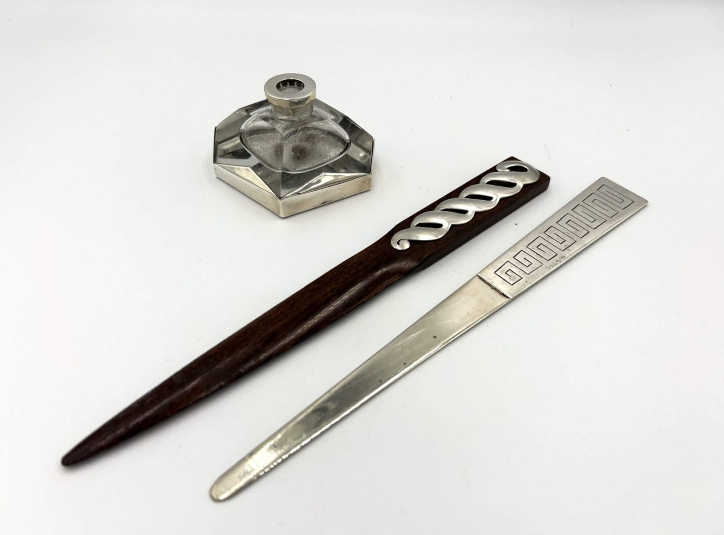 Vintage inkwell and letter openers on display.
