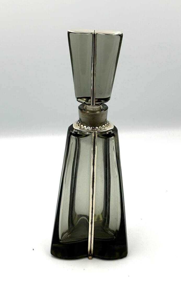Elegant geometric glass perfume bottle with stopper.