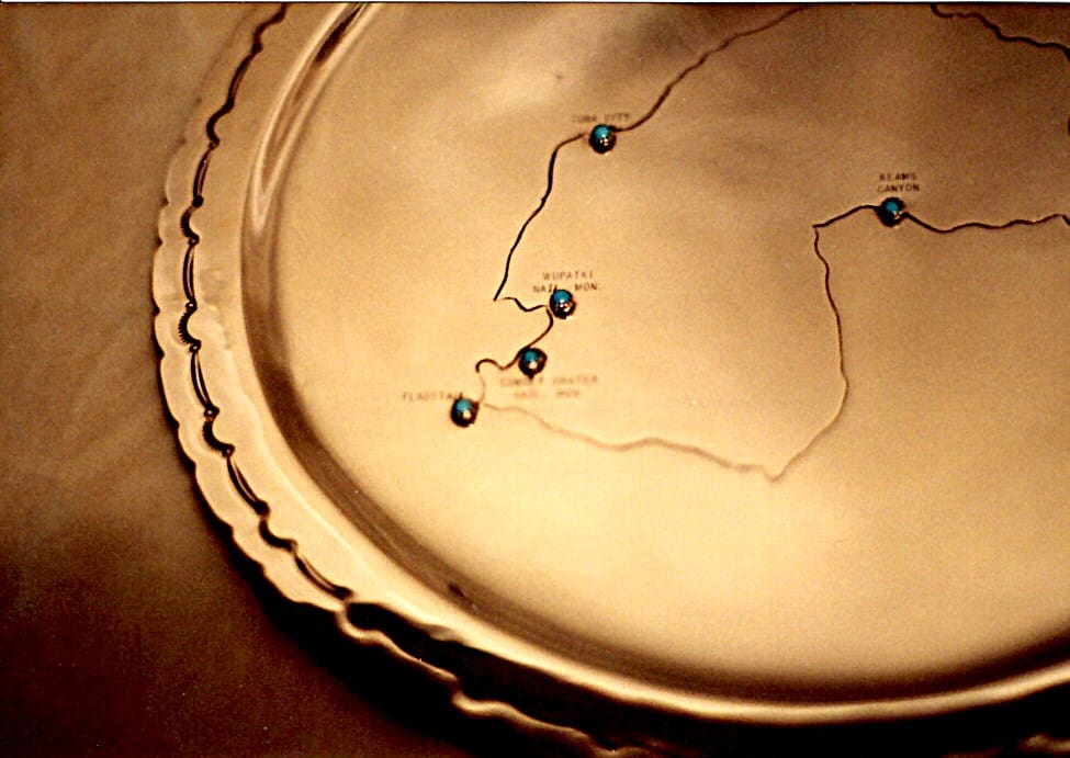 Decorative plate with engraved map and pins.