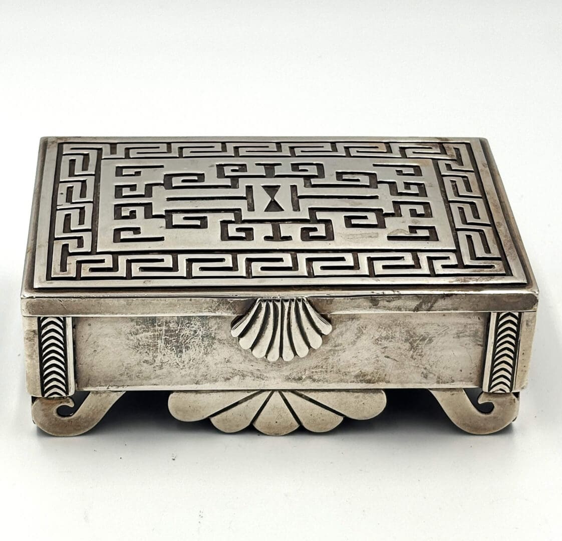 Ornate silver box with intricate geometric design.