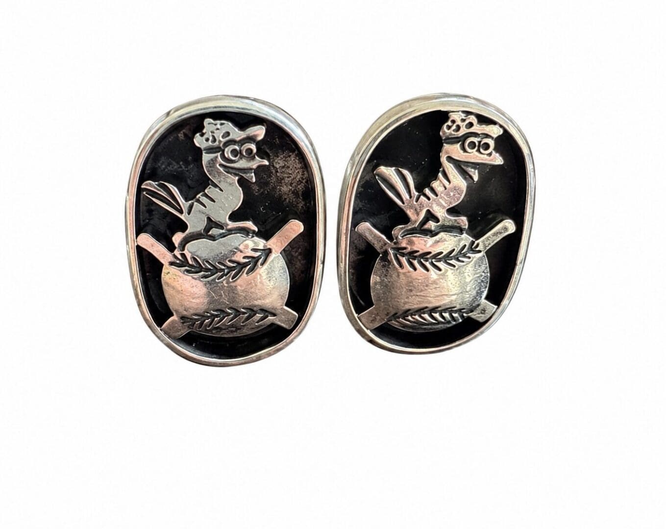 Pair of silver oval cufflinks with bird